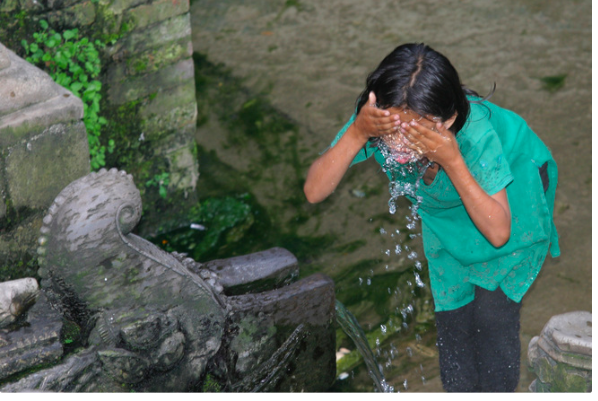Girl washing her face